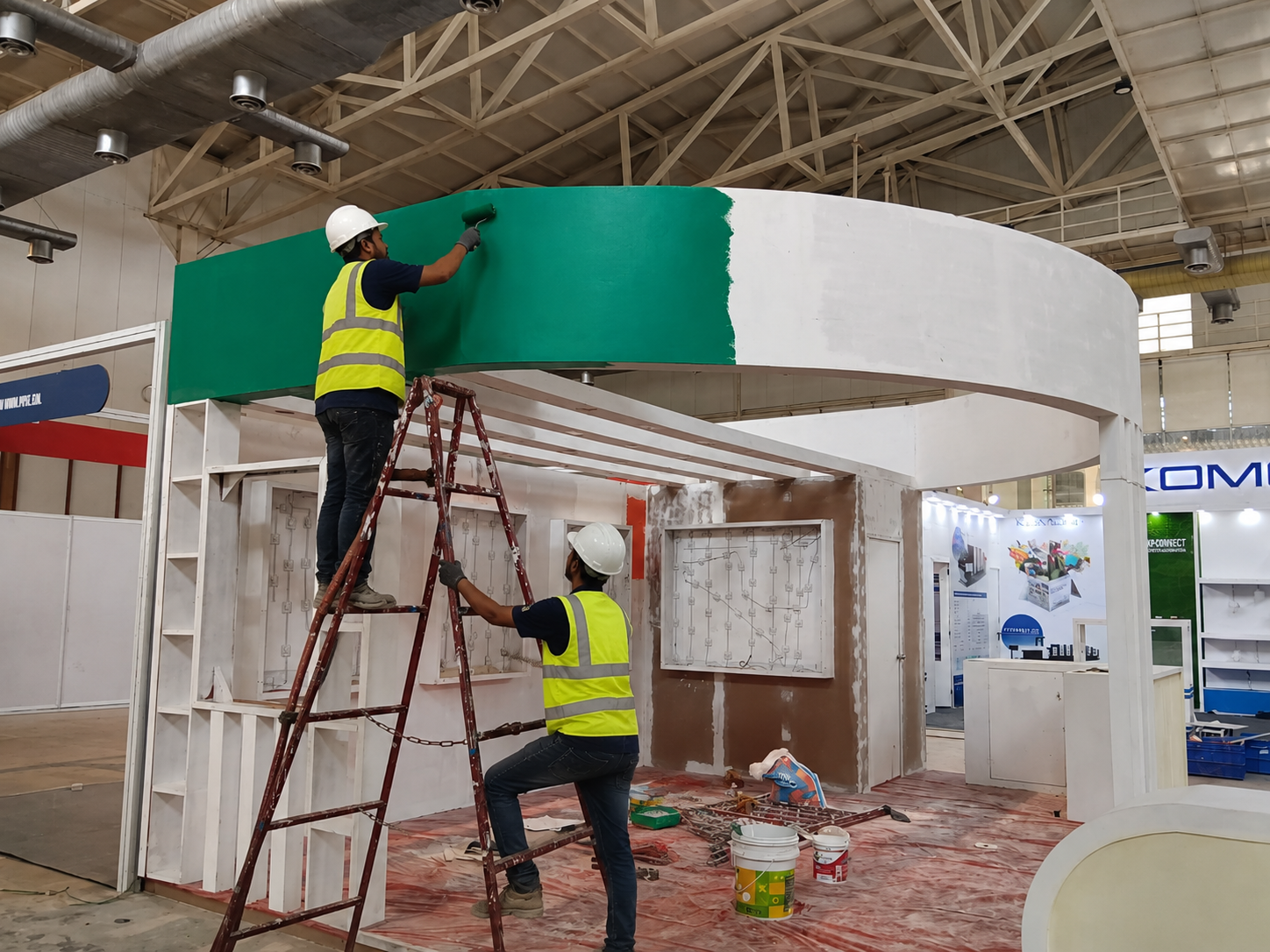 Site team finishing stall paintwork